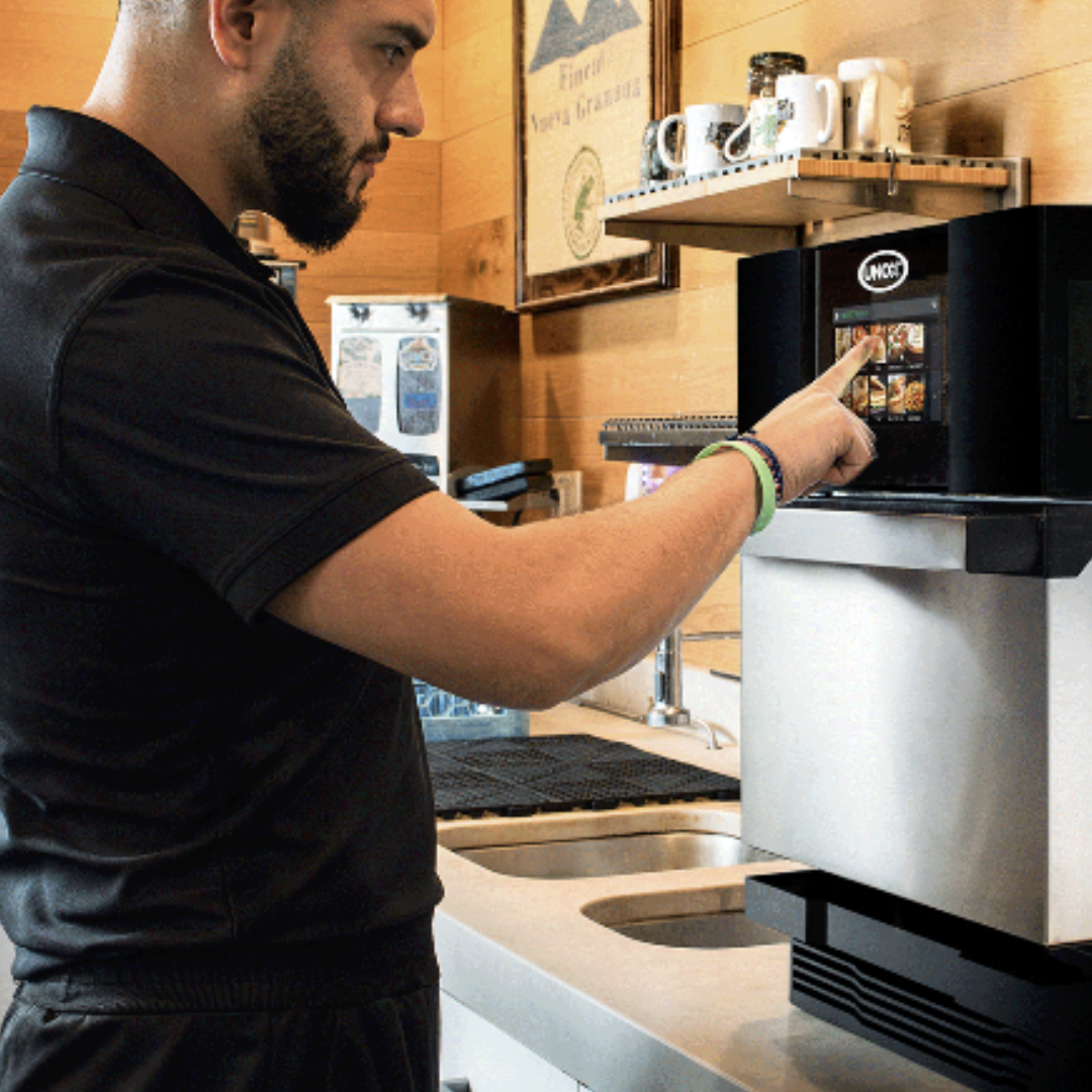 Man operating the Unox Speed Compact ECO Oven in bakery cafe venue